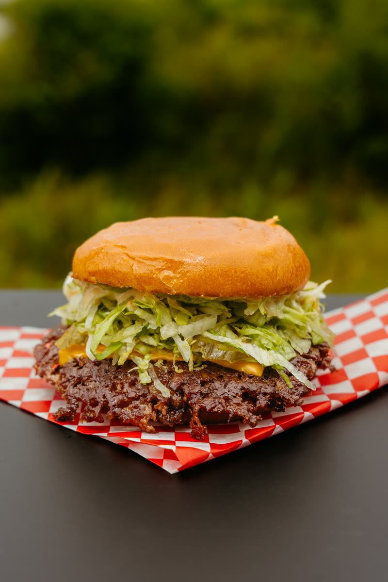 THE MACnificent — smash patties with double American cheese, pickles and iceberg on a toasted brioche bun