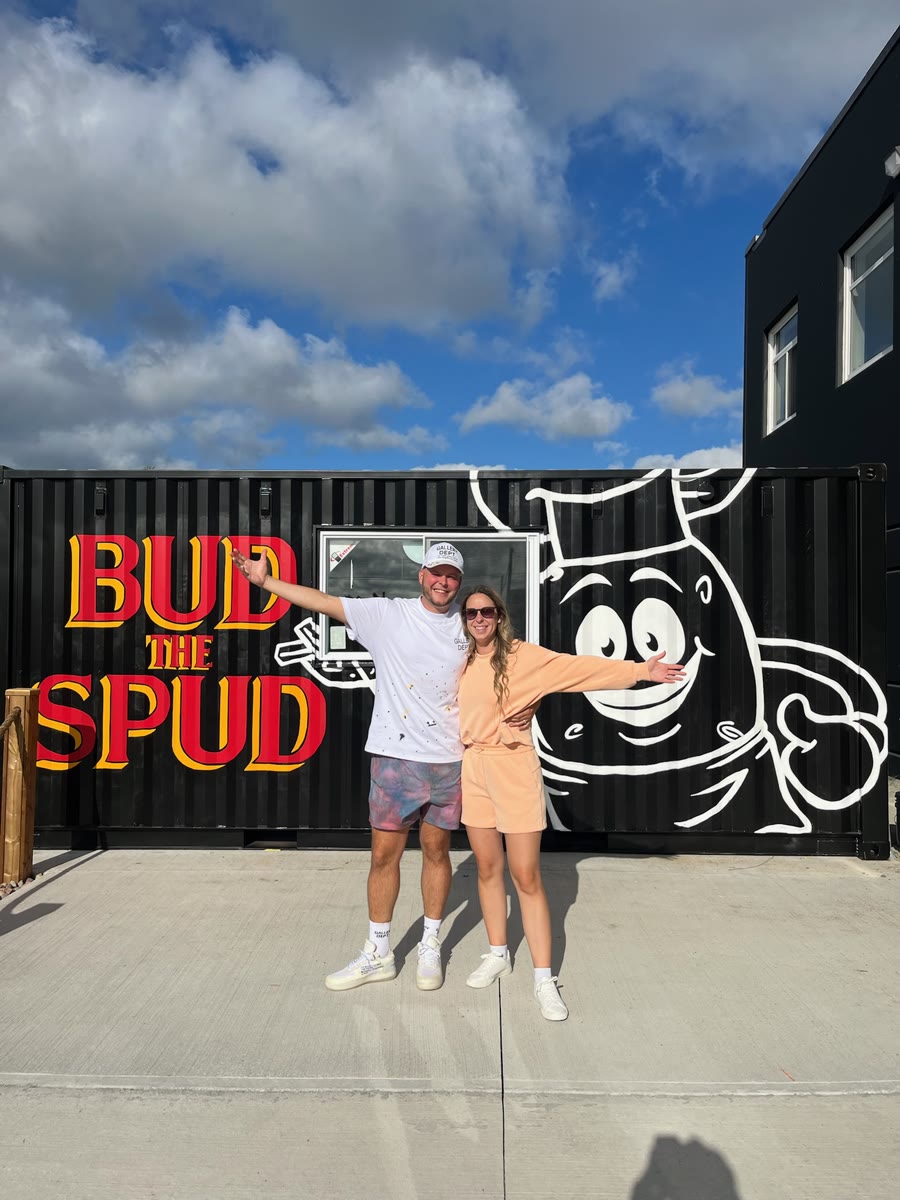 The current owners, Kyle Conrod and Kathleen Conrod, standing in front of one of the Bud the Spud locations.