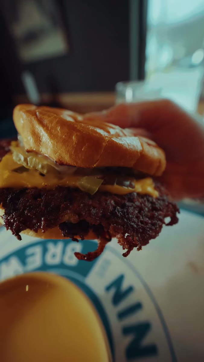 THE DIRTY DIPPER — crusty smash patties, melted American cheese, dill pickles and griddled onions on a toasted brioche bun